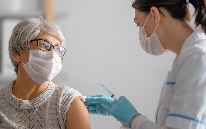 Doctor Giving A Senior Woman A Vaccination