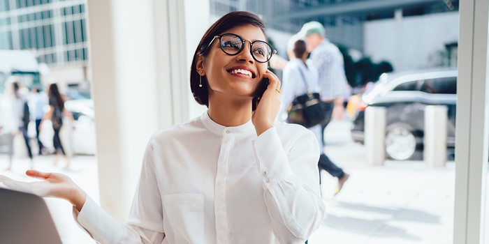 Cheerful Businesswoman Talking On Smartphone