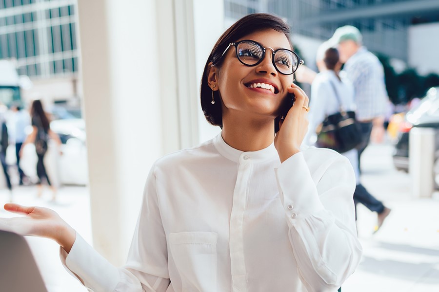 Cheerful Businesswoman Talking On Smartphone