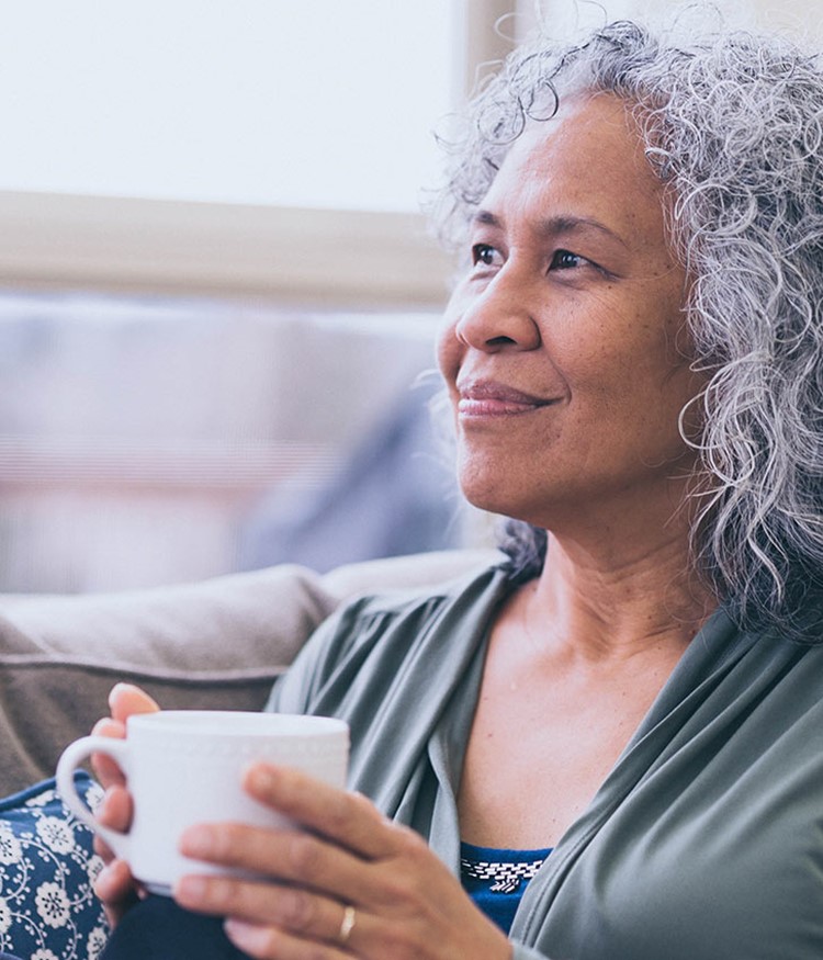 Mature Hawaiian Woman In The Early Morning With A Cup Of Tea And Contemplates The Day Ahead