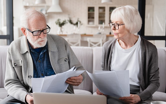 Serious Elderly Senior Grandparents Couple Reviewing Finance Documents