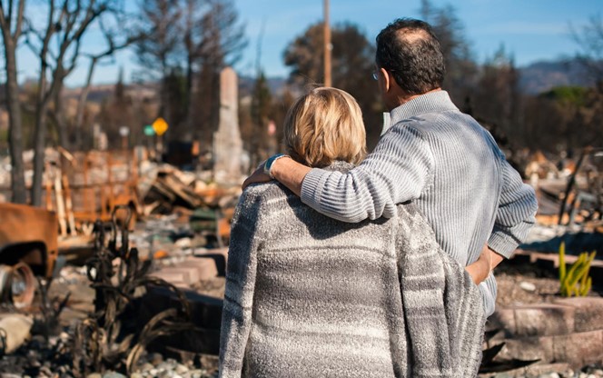 Senior Couple Checking Ruins After Fire Disaster