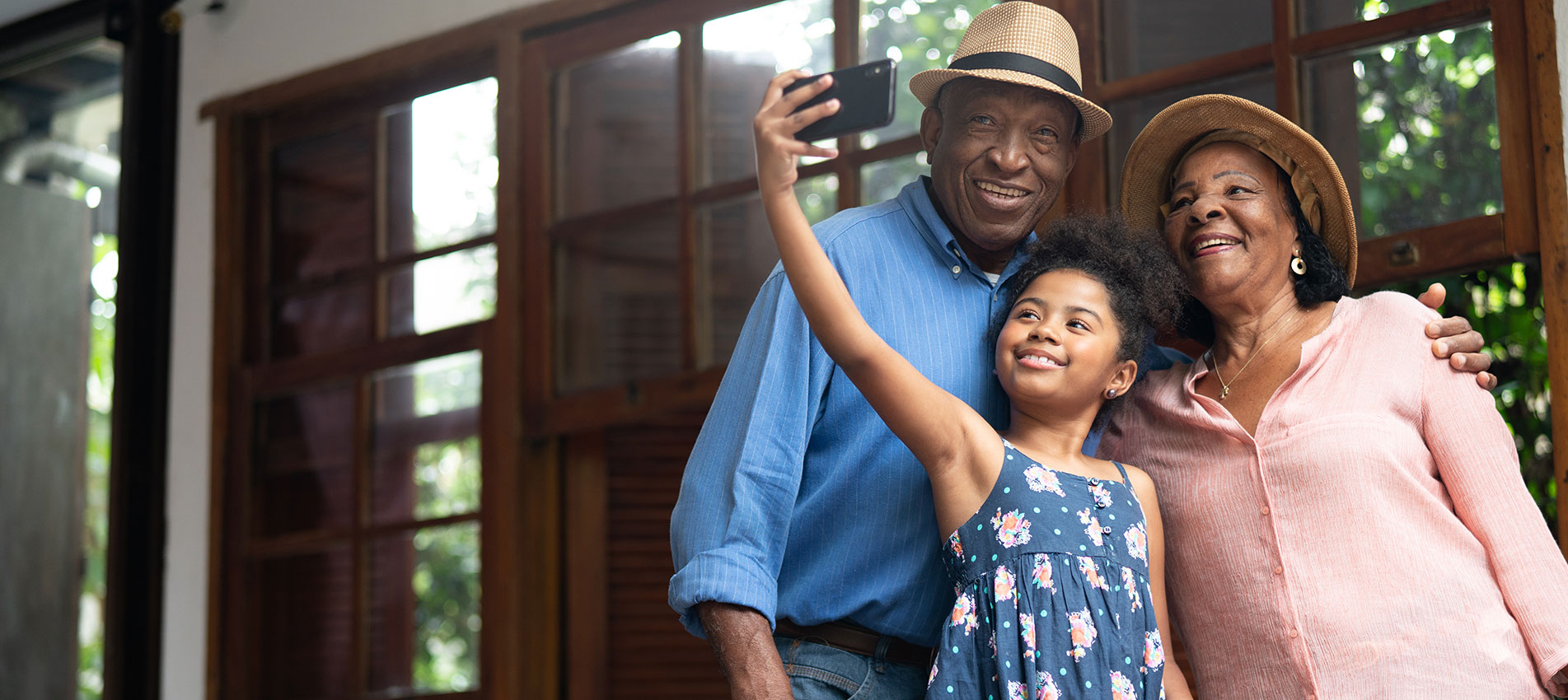 Grandparents And Granddaughter Taking Selfies