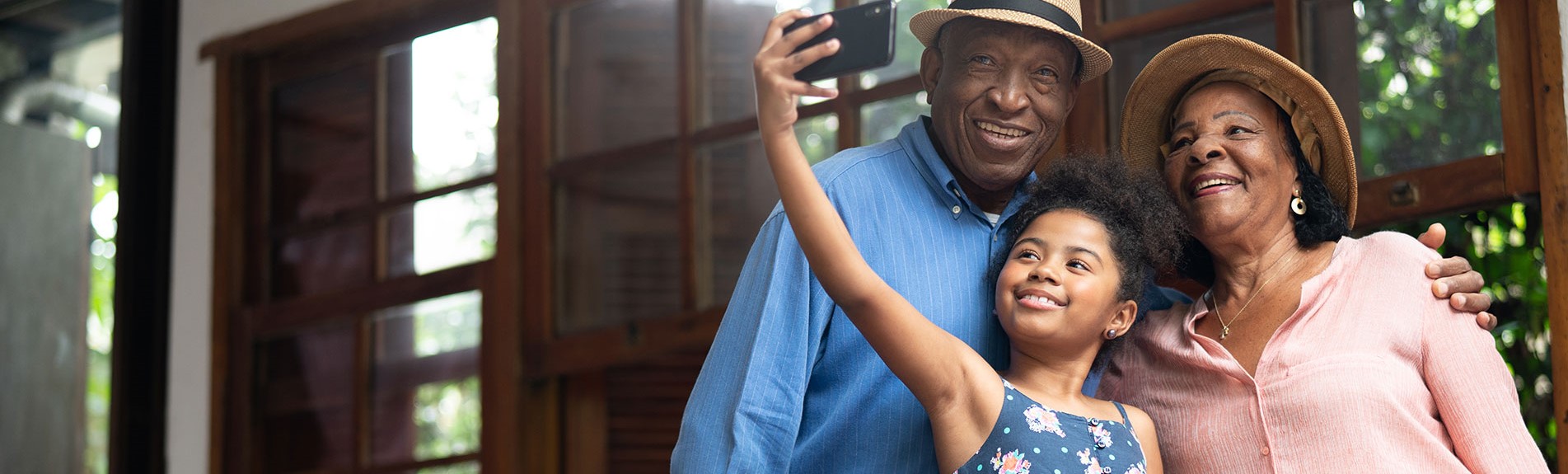 Grandparents And Granddaughter Taking Selfies