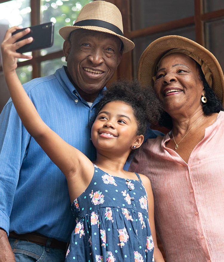 Grandparents And Granddaughter Taking Selfies
