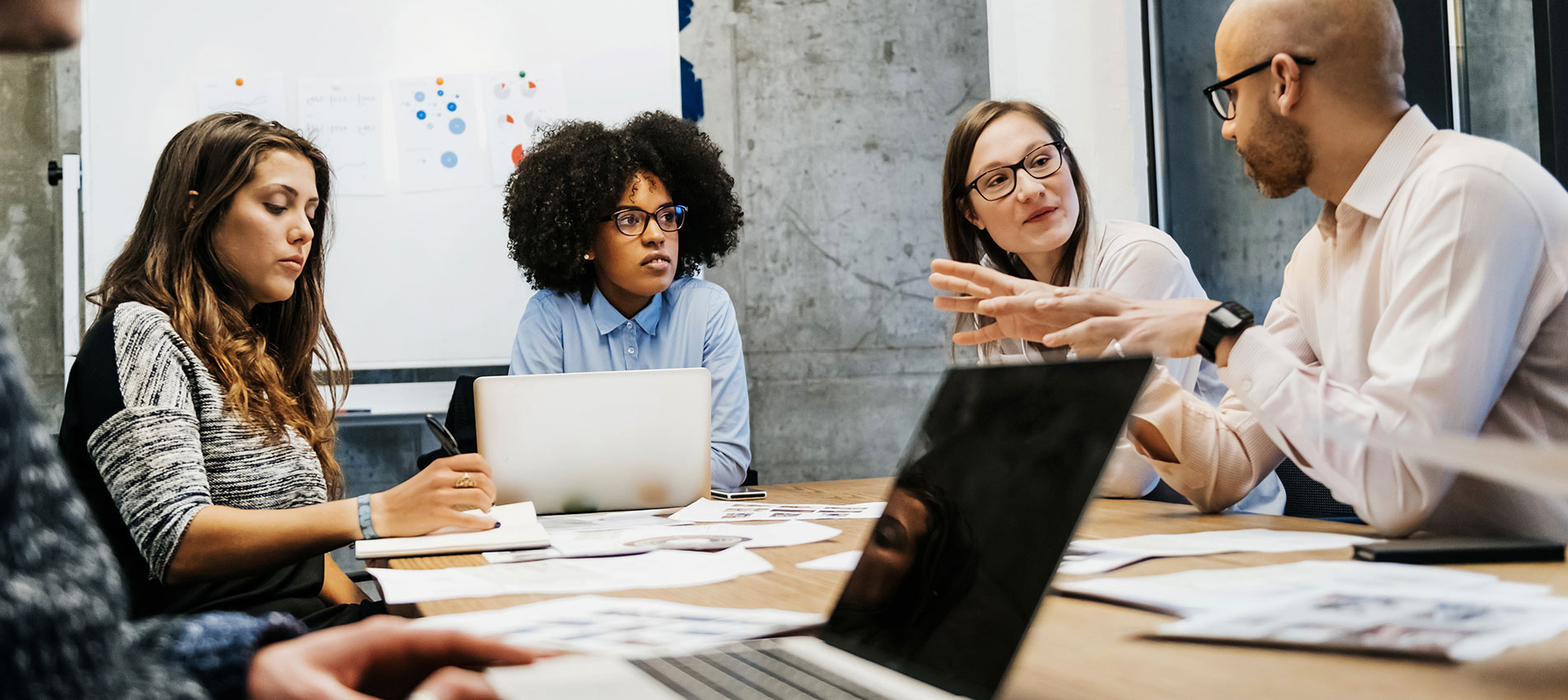 Three Women And Two Men In A Business Meeting