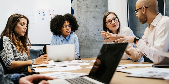 Three Women And Two Men In A Business Meeting