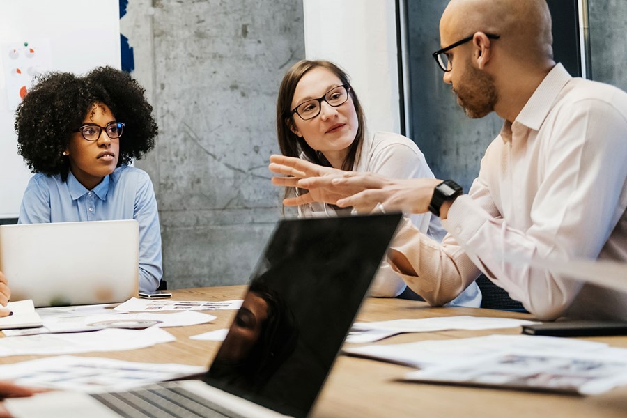 Three Women And Two Men In A Business Meeting
