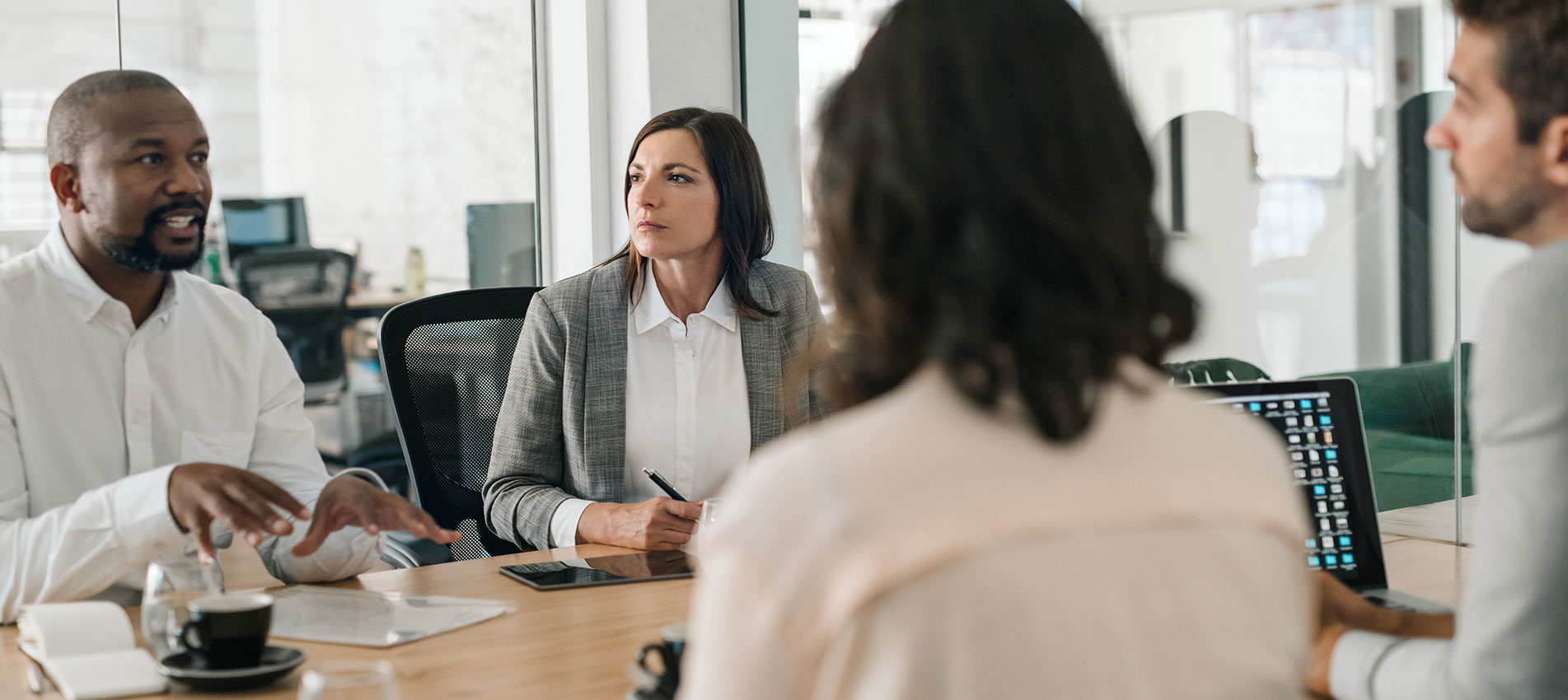Businessman Talking With Colleagues During An Office Meeting