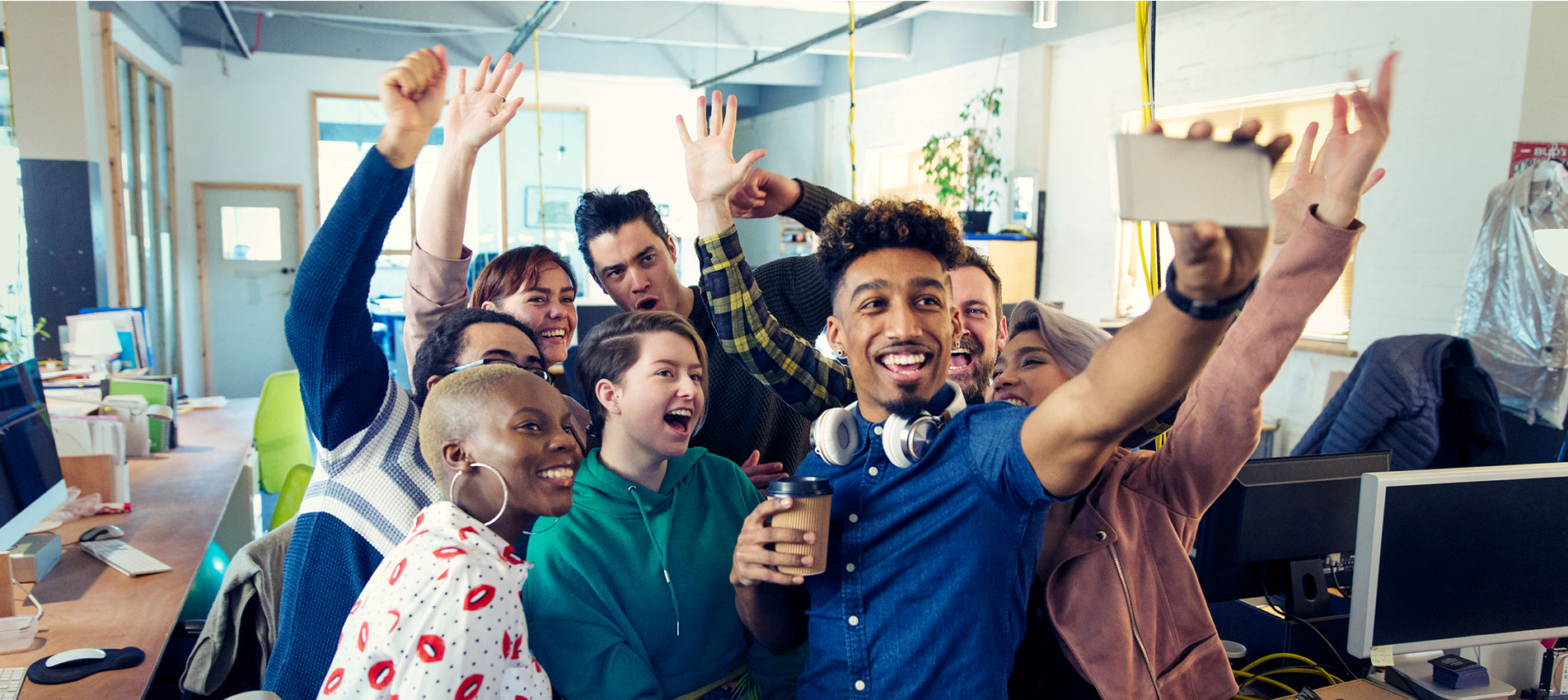 Enthusiastic creative business team taking selfie in office