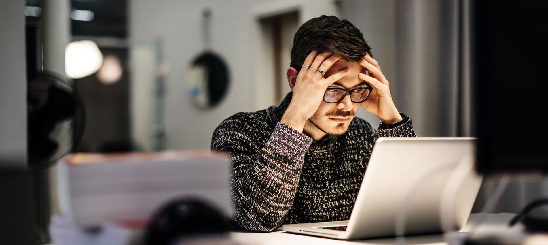 Young businessman holding his head and pondering