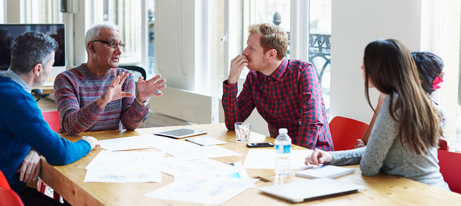 Coworkers discussing a project at conference table