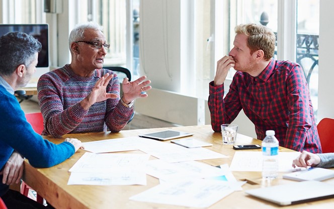 Coworkers discussing a project at conference table