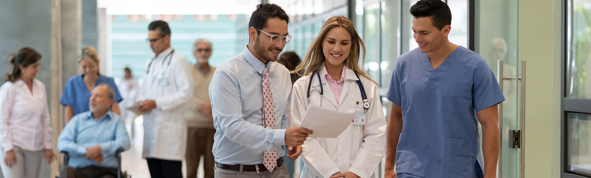 Hospital Manager Showing A Document To Doctor And Nurse