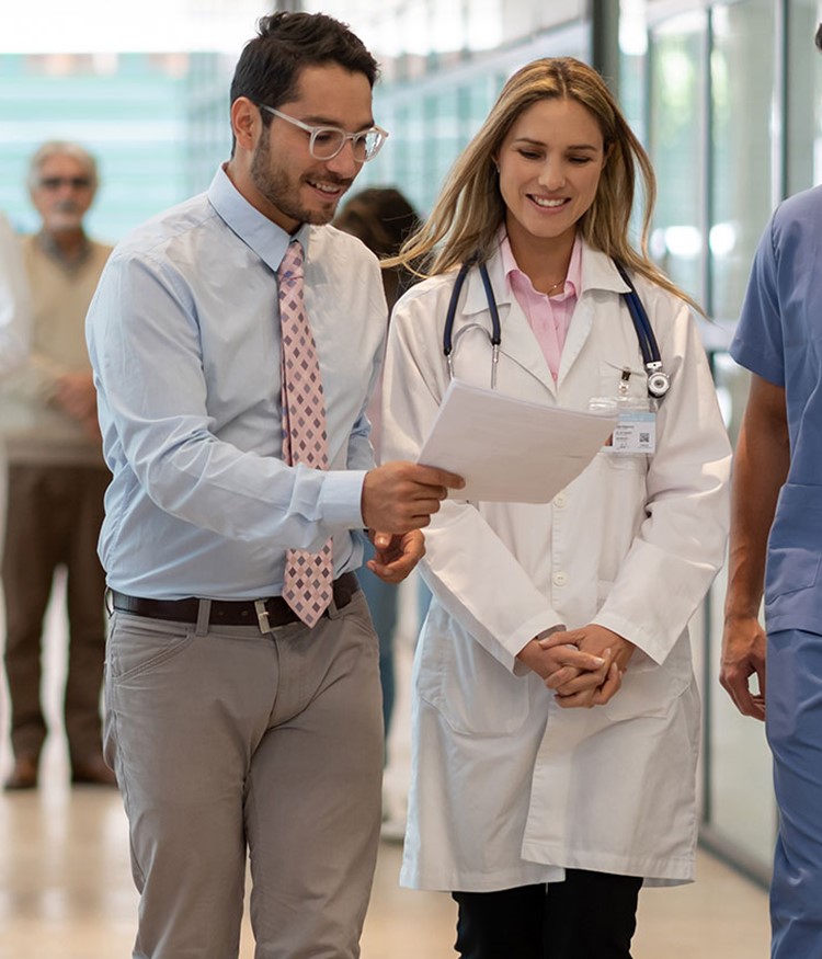 Hospital Manager Showing A Document To Doctor And Nurse