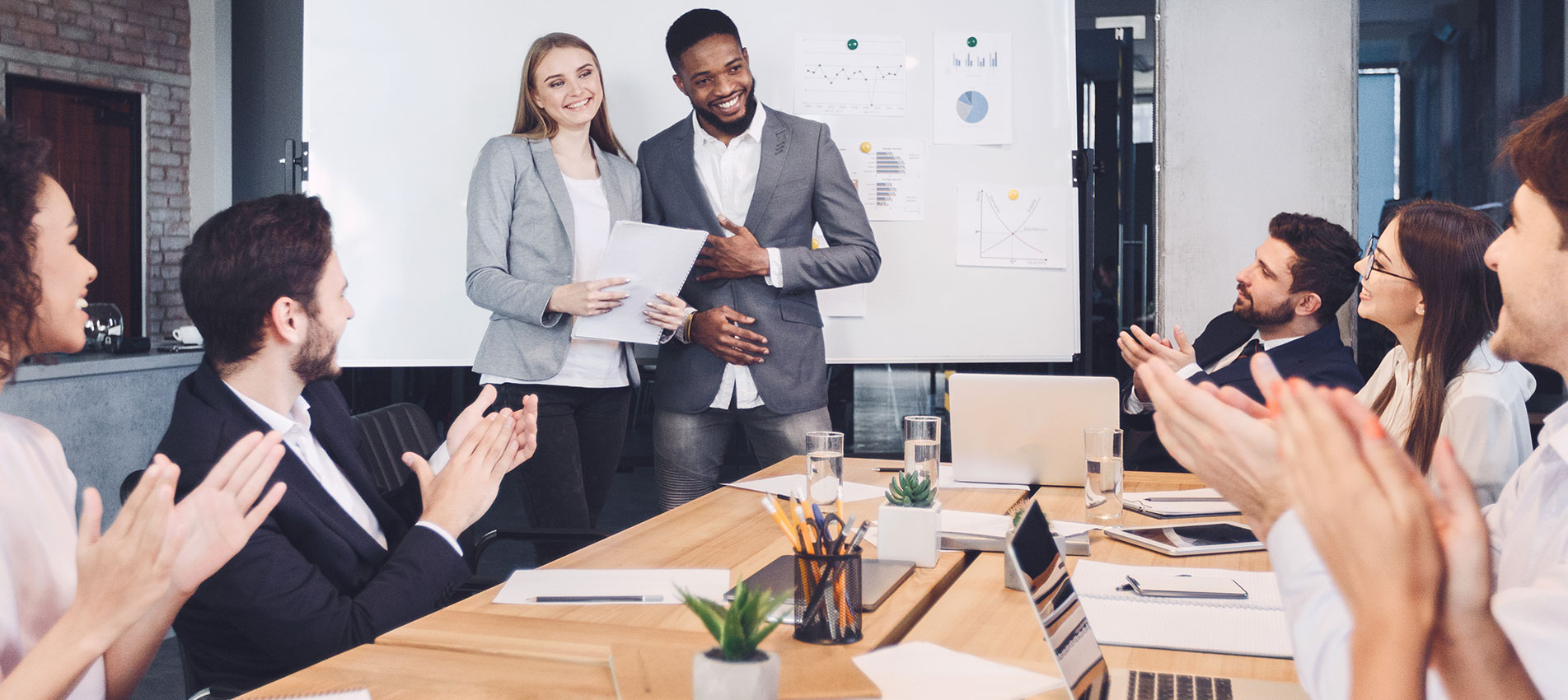 Boss welcoming new employee and representing to colleagues