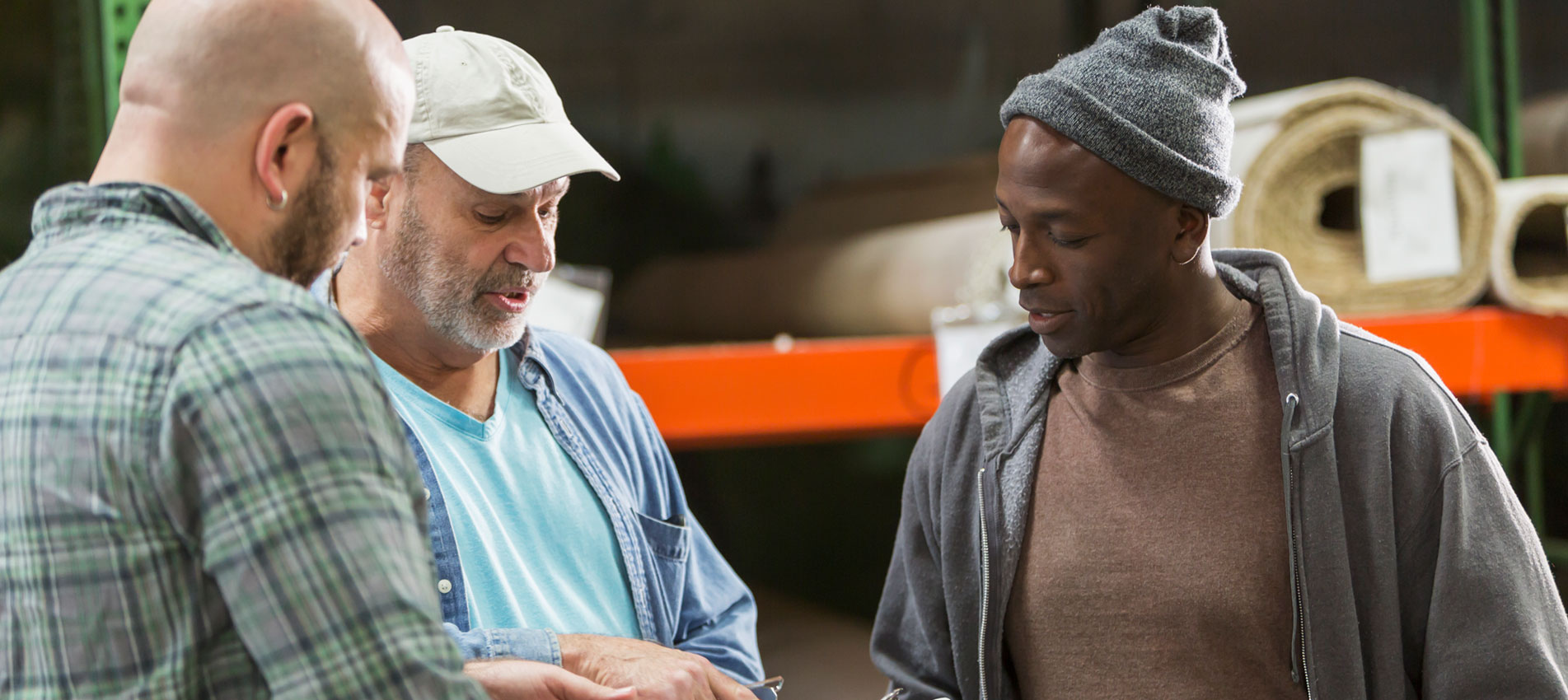 Three Men Working In Carpet Warehouse (1)