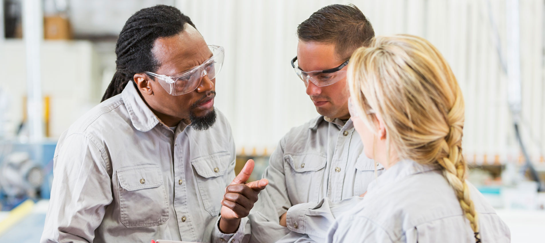 Workers In Factory Having Meeting