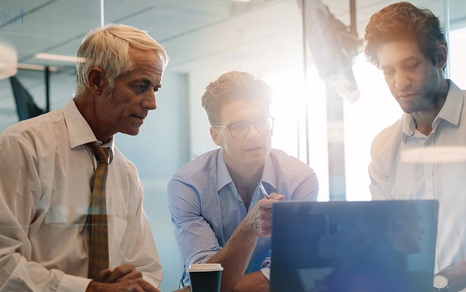 three men of different ages in meeting