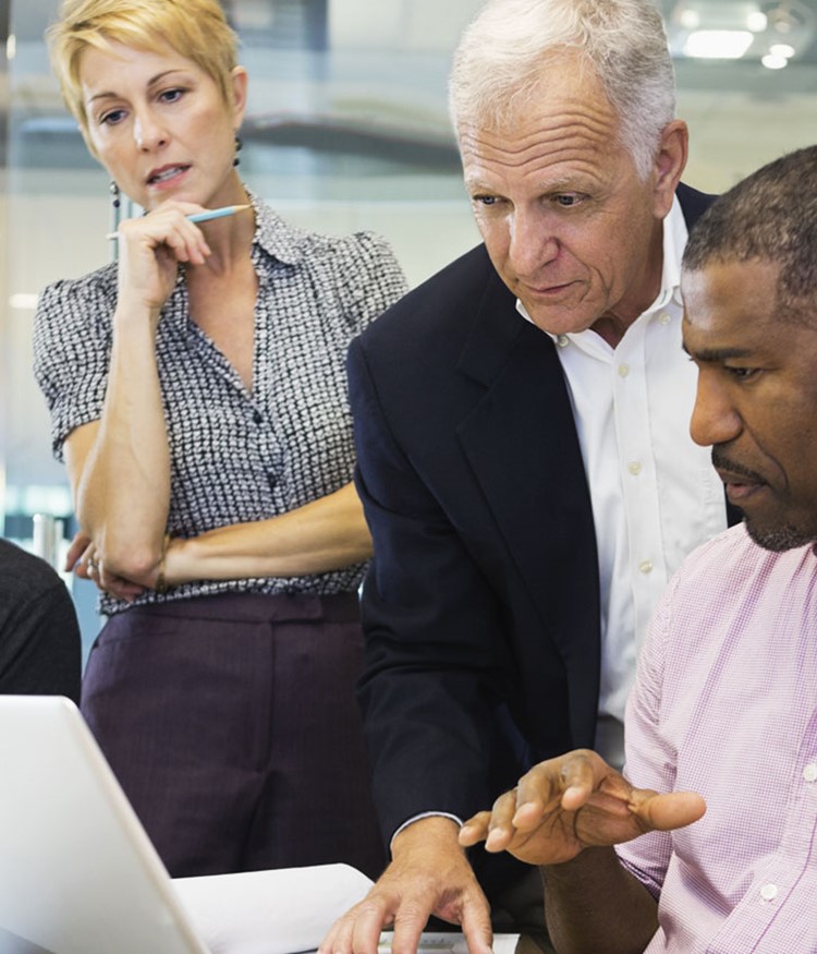 Business Colleagues Working On Laptop