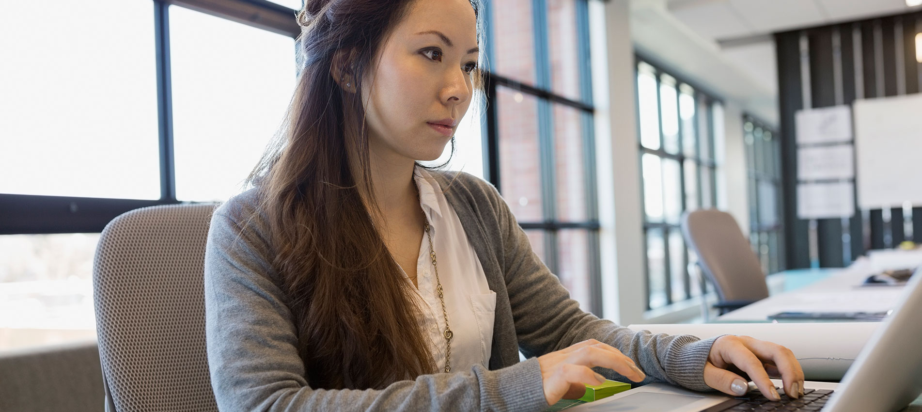 Female working at laptop in office