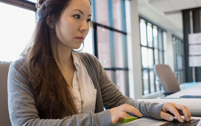 Female working on her laptop in the office