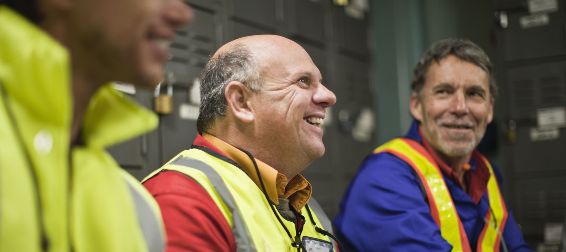 Workers Sitting In Locker Room