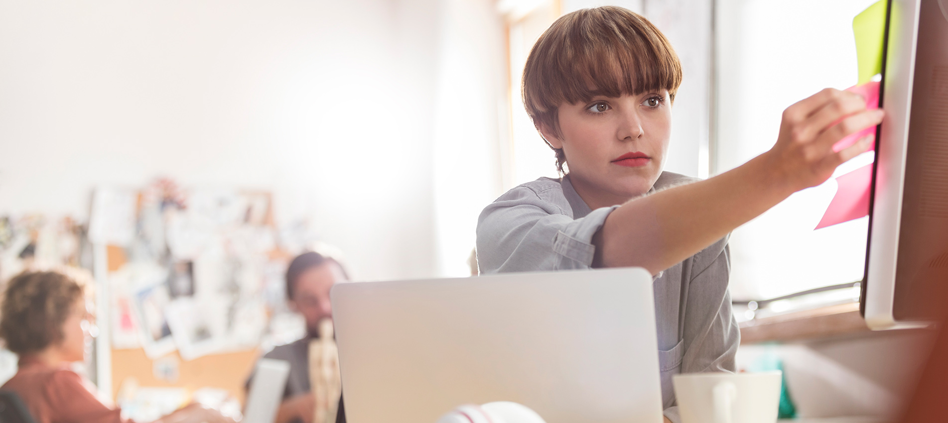 Woman Pasting Sticky Notes On Screen