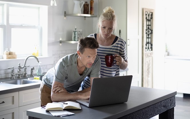 Couple Looking At A Laptop