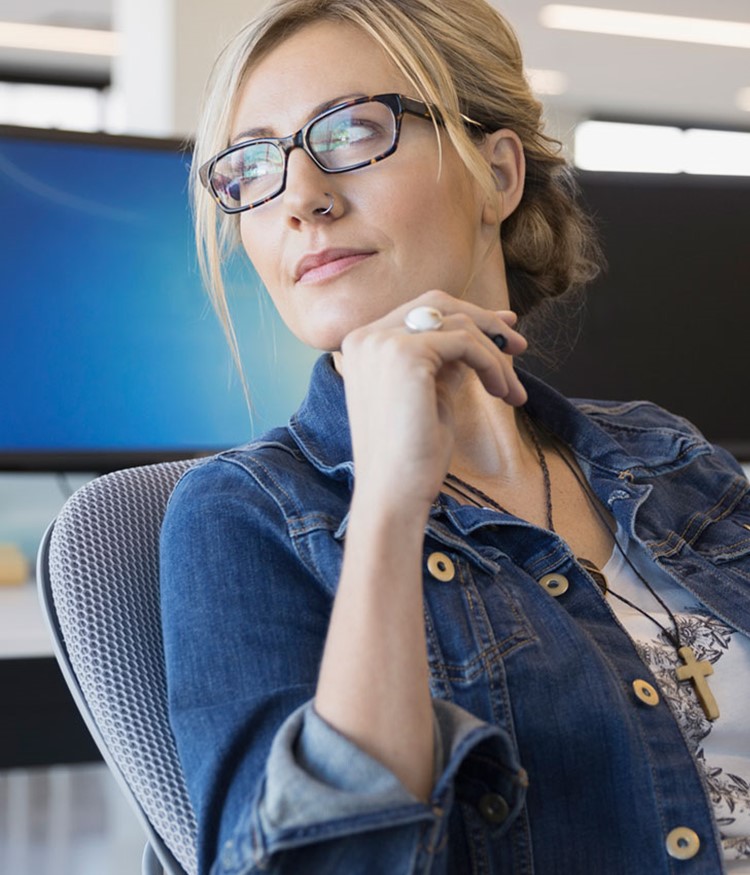 Pensive Businesswoman Looking Away In Office