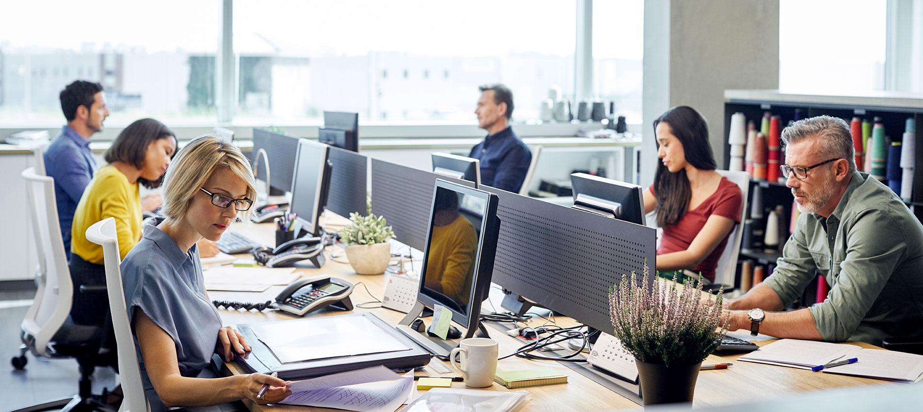 Business people working at desk by window