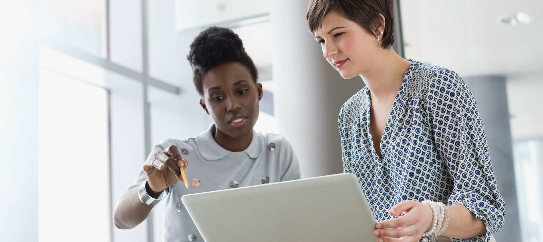 Businesswomen With Laptop Working In Office Building