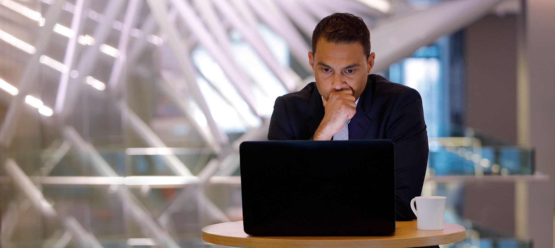 Serious businessman looking at a laptop