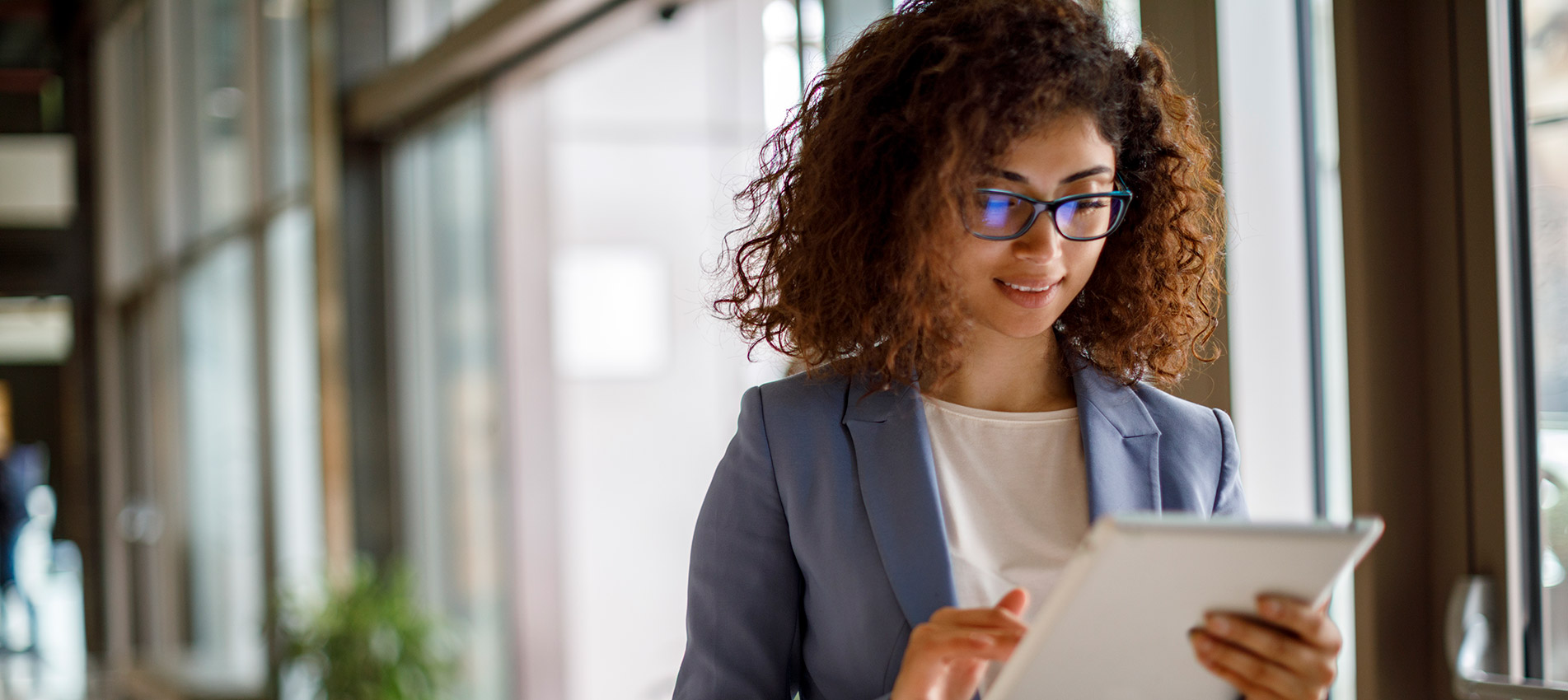 Young businesswoman using digital tablet indoors