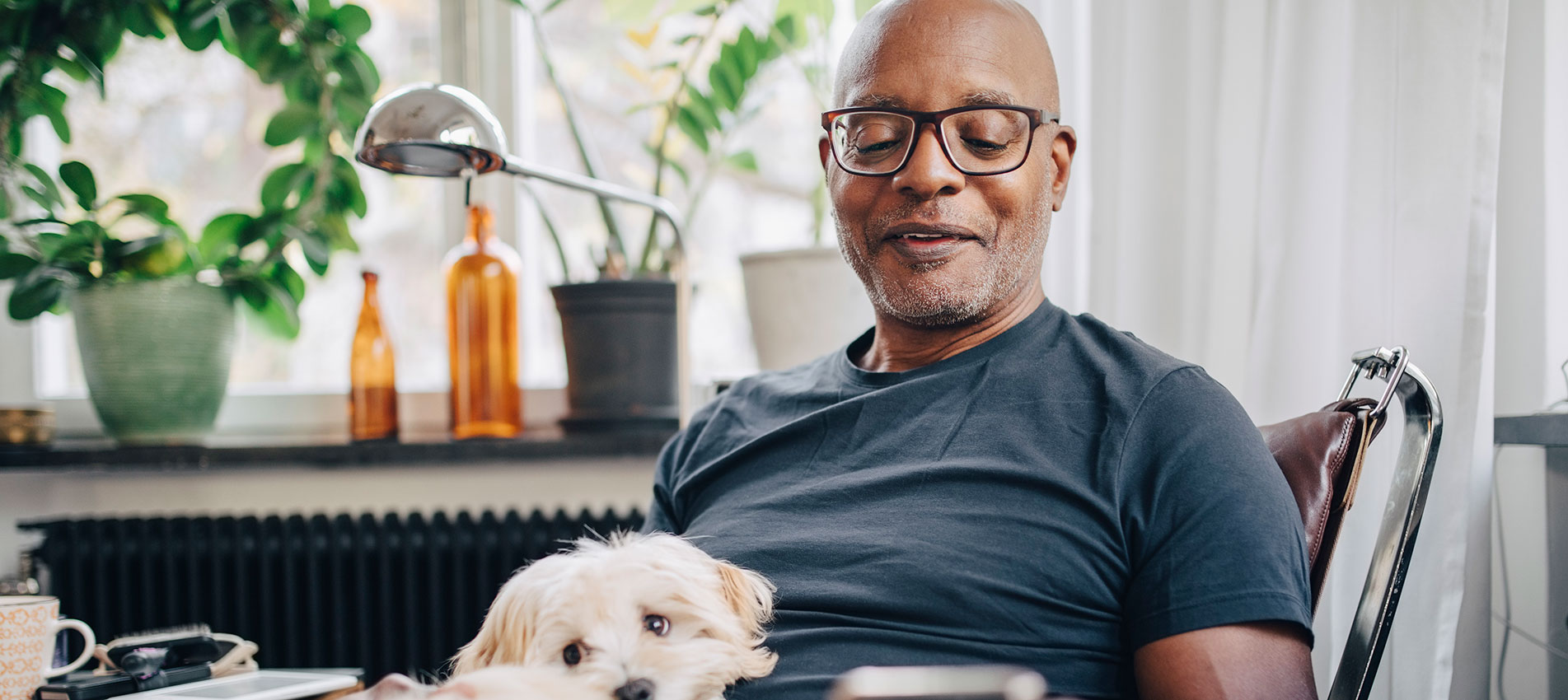 Retired senior male using smart phone at home
