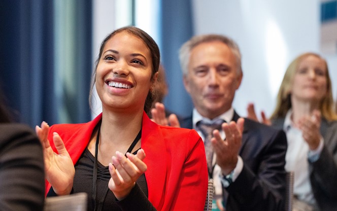 Business people applauding during launch event