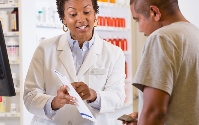 Customer Talking To Pharmacist