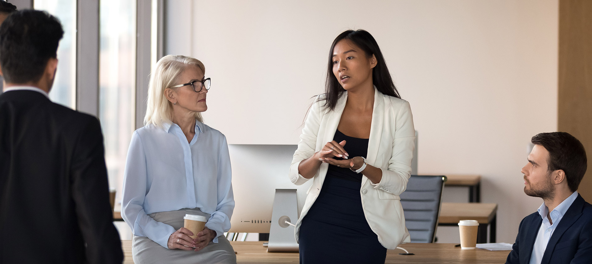 Asian Coach Speaking At Diverse Corporate Group Meeting