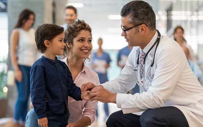 Male Pediatrician Talking To His Little Patient