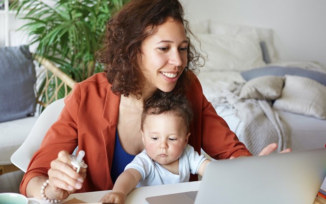 Woman Working At Home With Her Baby