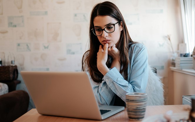 Worried Girl Looking At Laptop At Home
