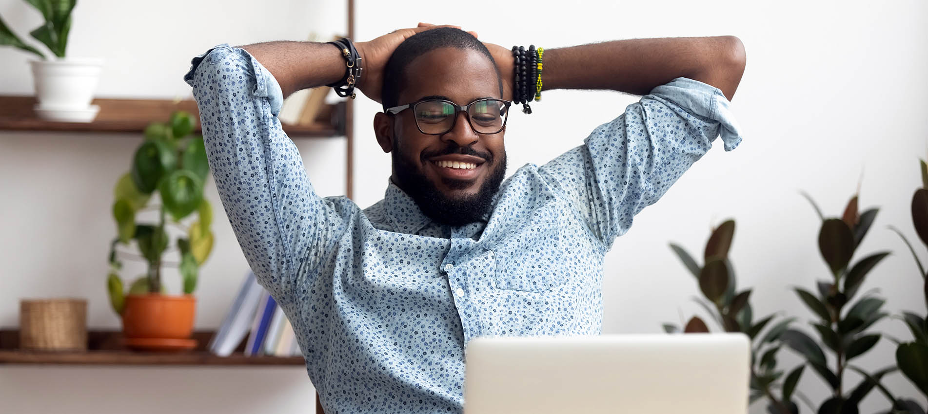 Young Black Man With Laptop Relaxed And Feeling No Stress