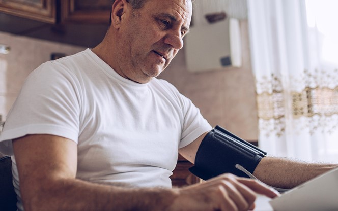 Man Measures Blood Pressure