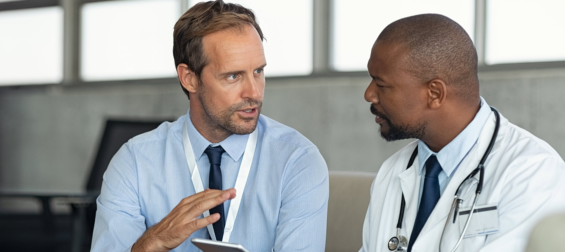 Doctor In Conversation With Pharmaceutical Representative