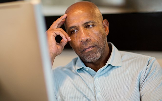 Mature African American Man Looking Stressed Working From Home