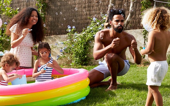 Family Playing In Backyard