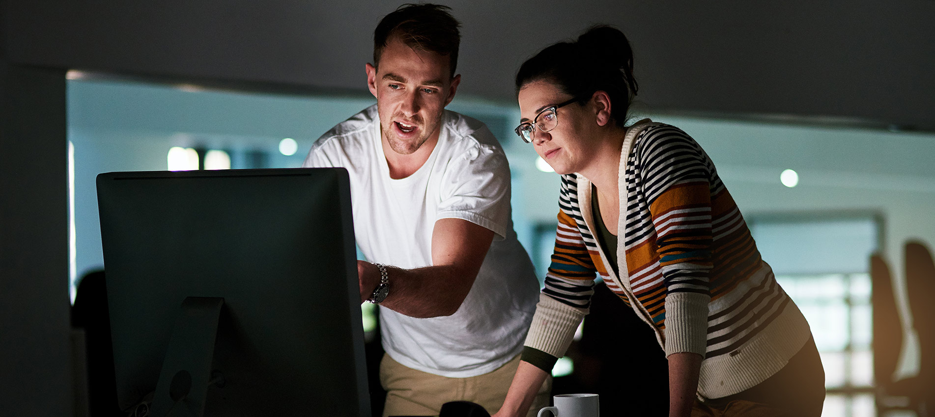 Computer Programmers Working Late To Complete An Assignment