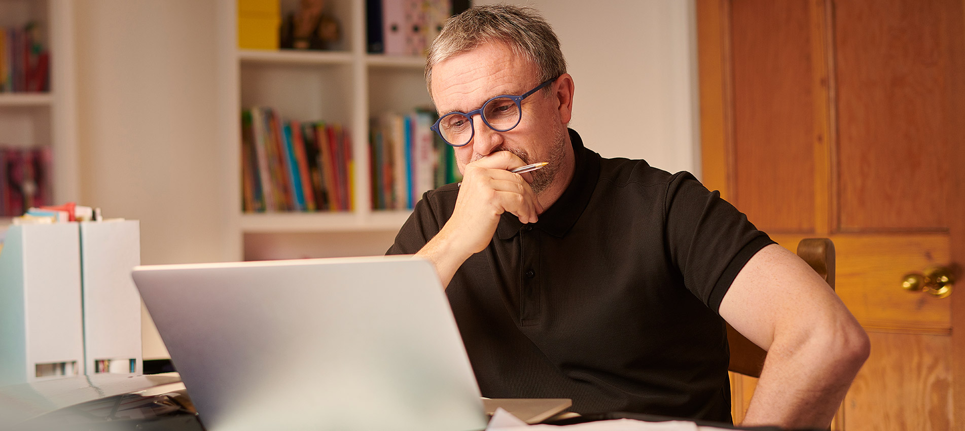 Mature Man Working On His Laptop From Home Looking Concerned