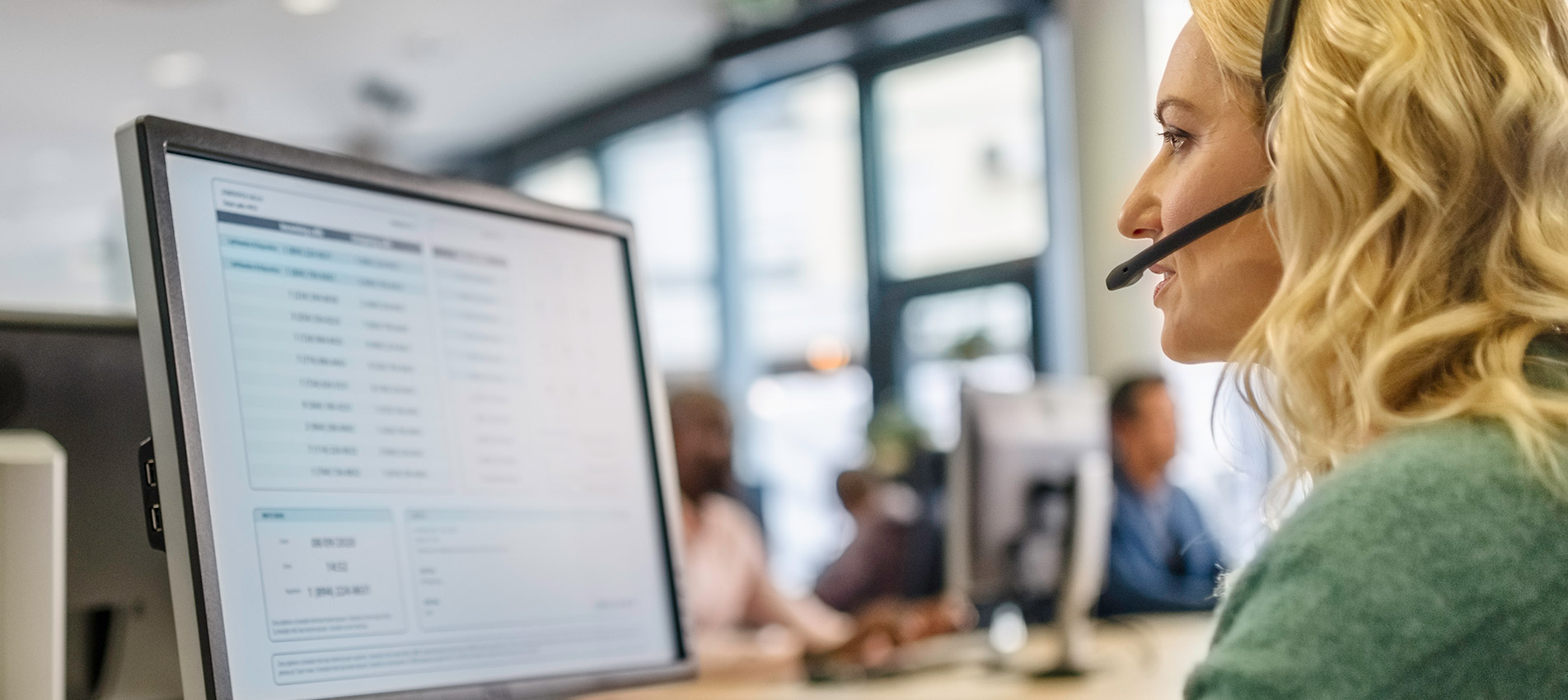 Woman With A Headset Using A Computer In A Call Centre