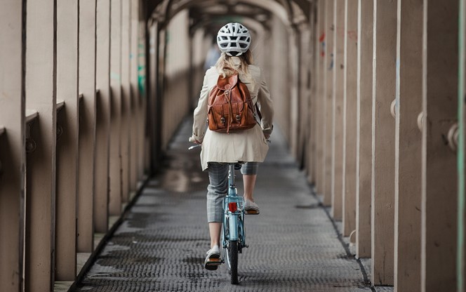 Young Lady Riding A Bike To Work
